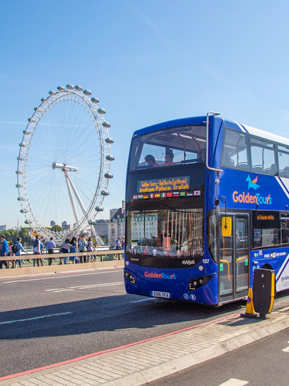 Hop on Hop off London bus near the London Eye on a sunny day.