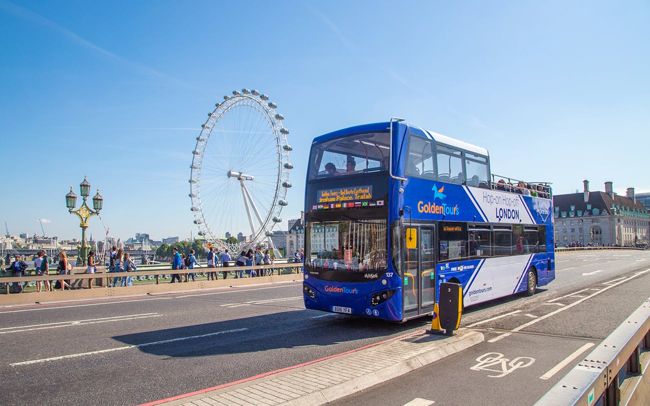 Hop on Hop off London bus near the London Eye on a sunny day.