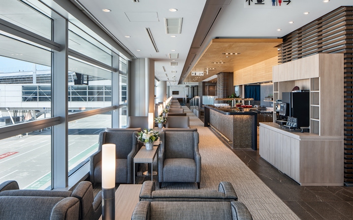 Plaza Premium Lounge seating area with runway view at Chubu Centrair International Airport.