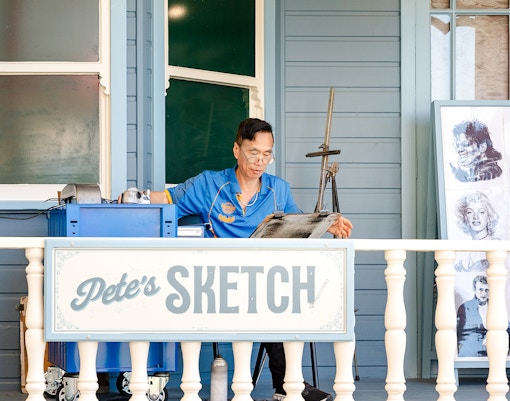 Pete's Sketch at Dreamworld theme park entrance with colorful architecture and lively visitors.