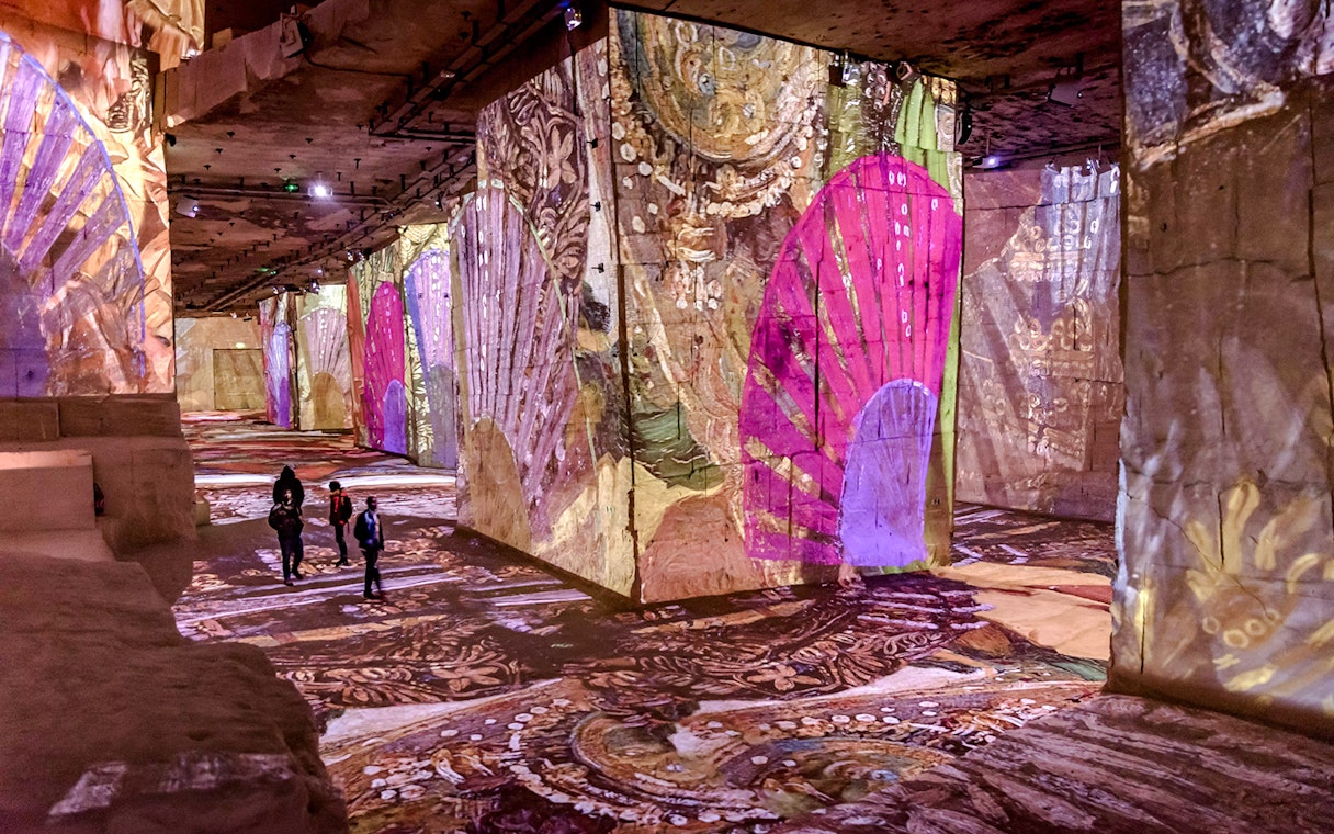 Frida Kahlo artwork projected on walls at Carrières des Lumières, Paris exhibition.