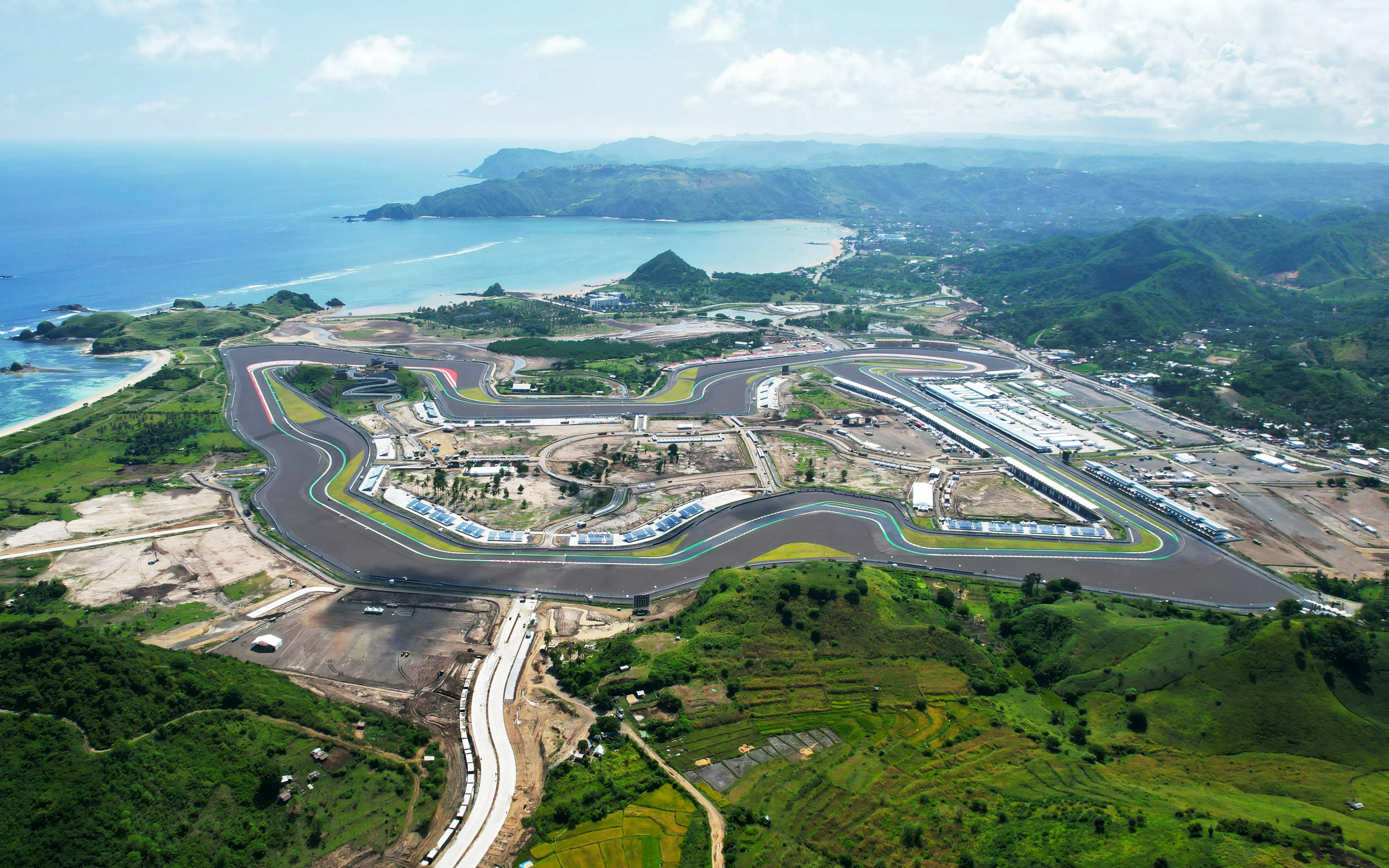 Aerial view of Mandalika Circuit in Lombok, Indonesia, with surrounding landscape and coastline.