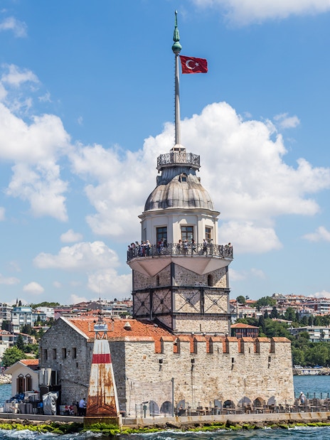 Maiden's Tower on Bosphorus Strait with Istanbul cityscape in the background.