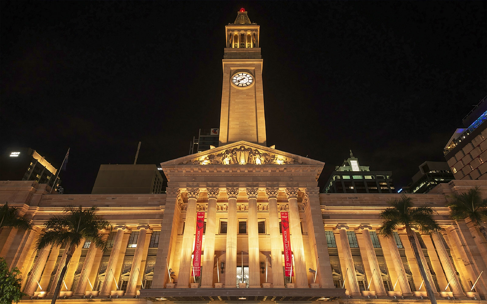Brisbane City Hall illuminated at night, related to true crime stories tour.