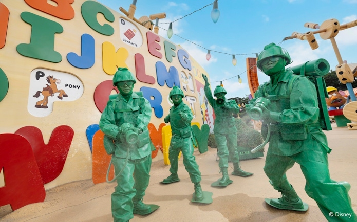 Toy soldiers from Toy Story at Disneyland Hong Kong in front of colorful alphabet wall.
