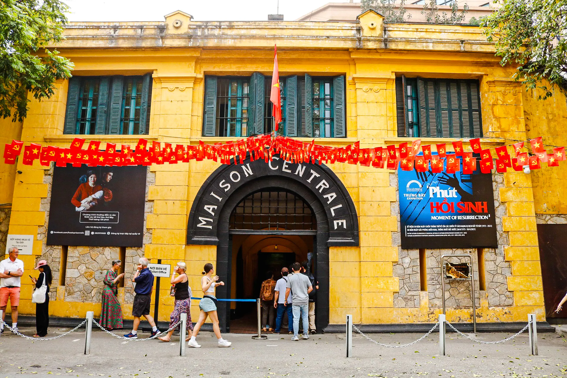 Hoa Lo Prison entrance with visitors in Hanoi, part of the Vietnamese Women Museum and Hoa Lo Prison Walking Tour.