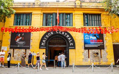 Hoa Lo Prison entrance with visitors in Hanoi, part of the Vietnamese Women Museum and Hoa Lo Prison Walking Tour.