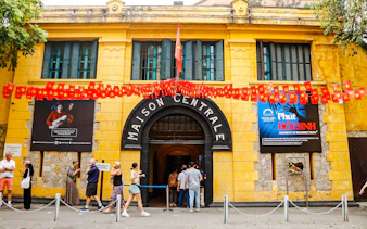 Hoa Lo Prison entrance with visitors in Hanoi, part of the Vietnamese Women Museum and Hoa Lo Prison Walking Tour.