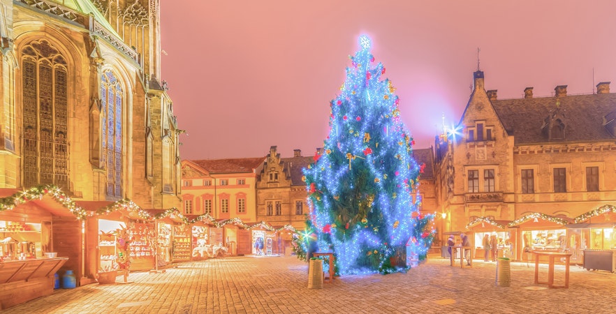 Prague Castle Christmas Market with decorated tree and festive stalls.