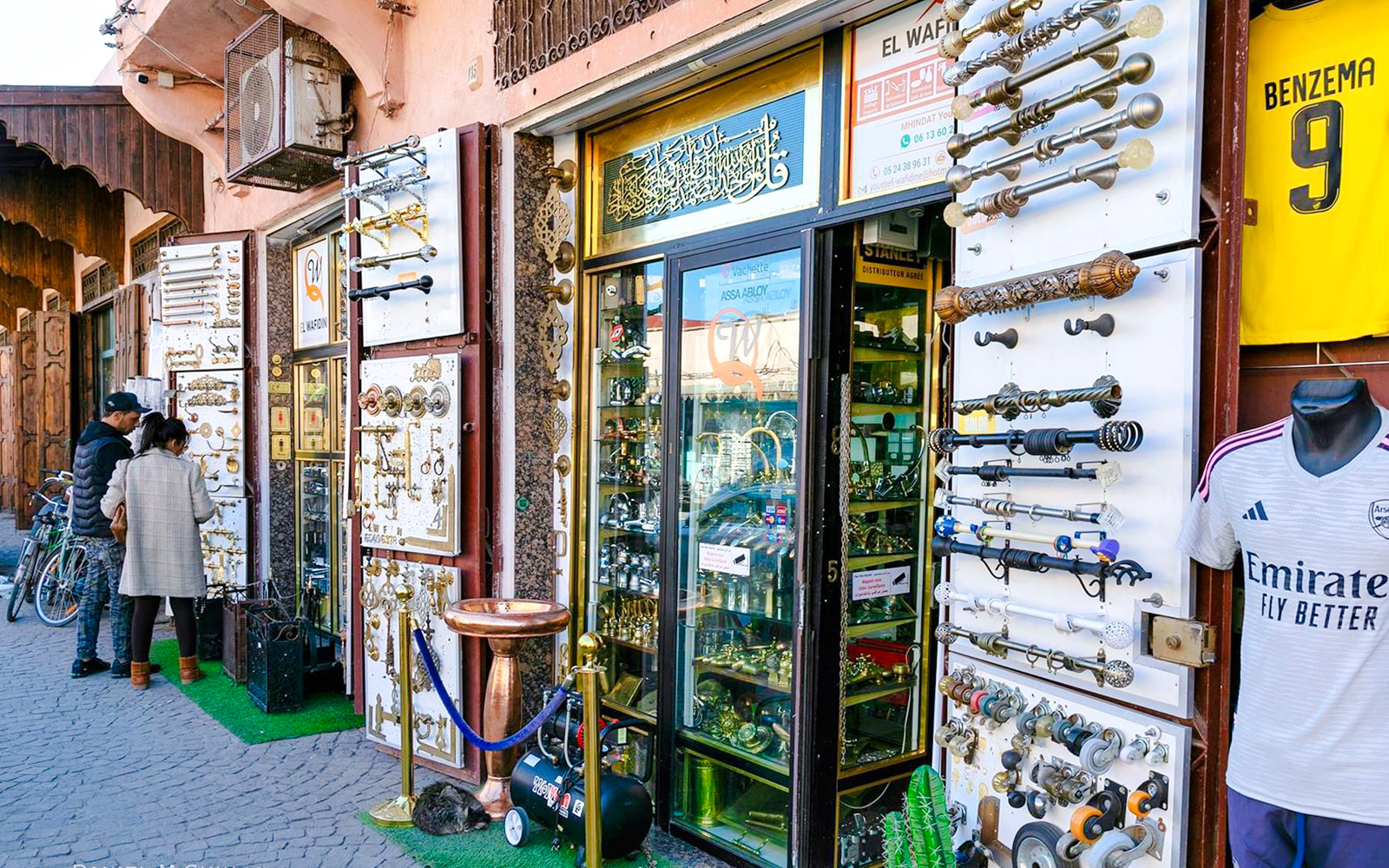 Shopfront displaying metalwork and hardware in Marrakesh souk, Morocco.