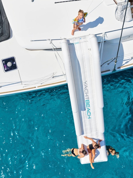 Catamaran with slide into blue sea, Spinalonga, Crete.