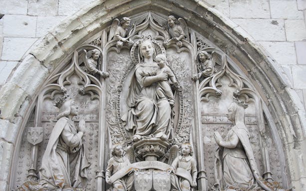 Royal Amboise Castle stone relief with religious figures and intricate carvings.