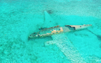 Staniel Cay plane wreck submerged in clear waters near Compass Cay, Exumas, Bahamas.