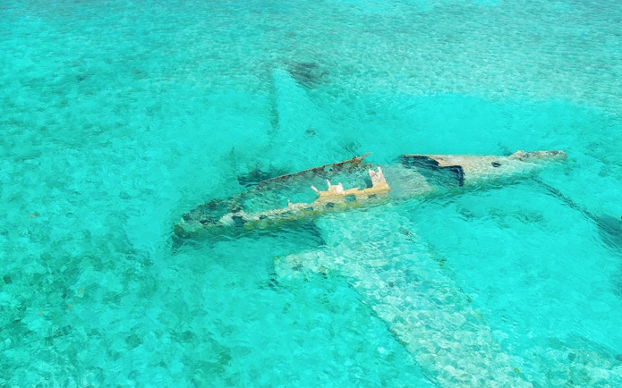 Staniel Cay plane wreck submerged in clear waters near Compass Cay, Exumas, Bahamas.