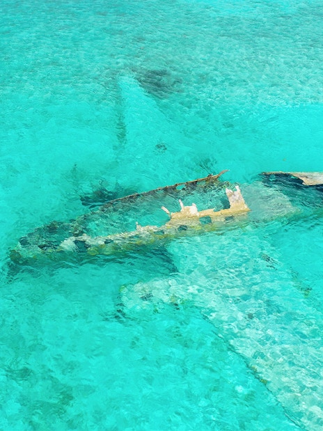 Staniel Cay plane wreck submerged in clear waters near Compass Cay, Exumas, Bahamas.