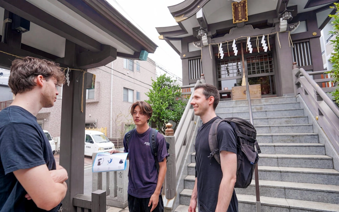 Visitors discussing outside a Tokyo shrine during a Samurai experience tour.
