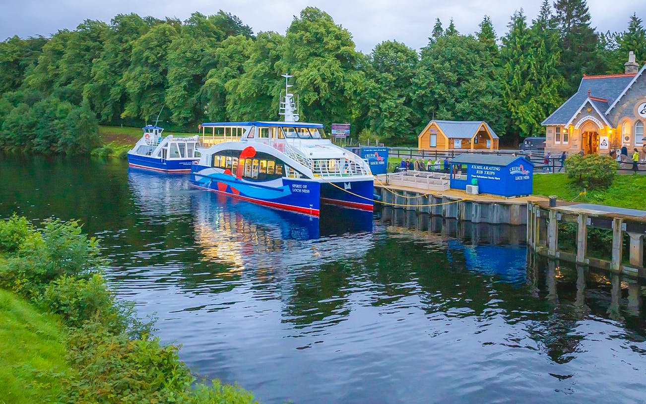 Loch Ness cruise boat docked near Urquhart Castle on Outlander day tour from Inverness.