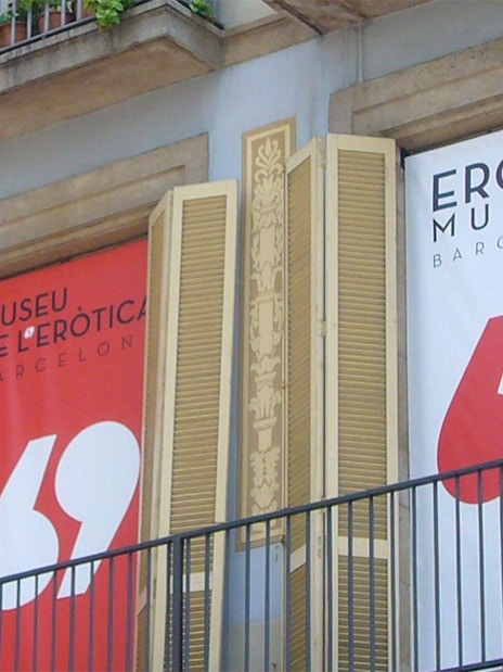 Erotic Museum Barcelona entrance with banners and balcony.