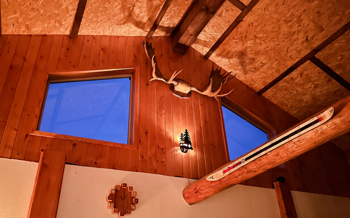 Interior of Aurora Borealis Viewing Lodge with wooden walls and antler decor, Alaska.