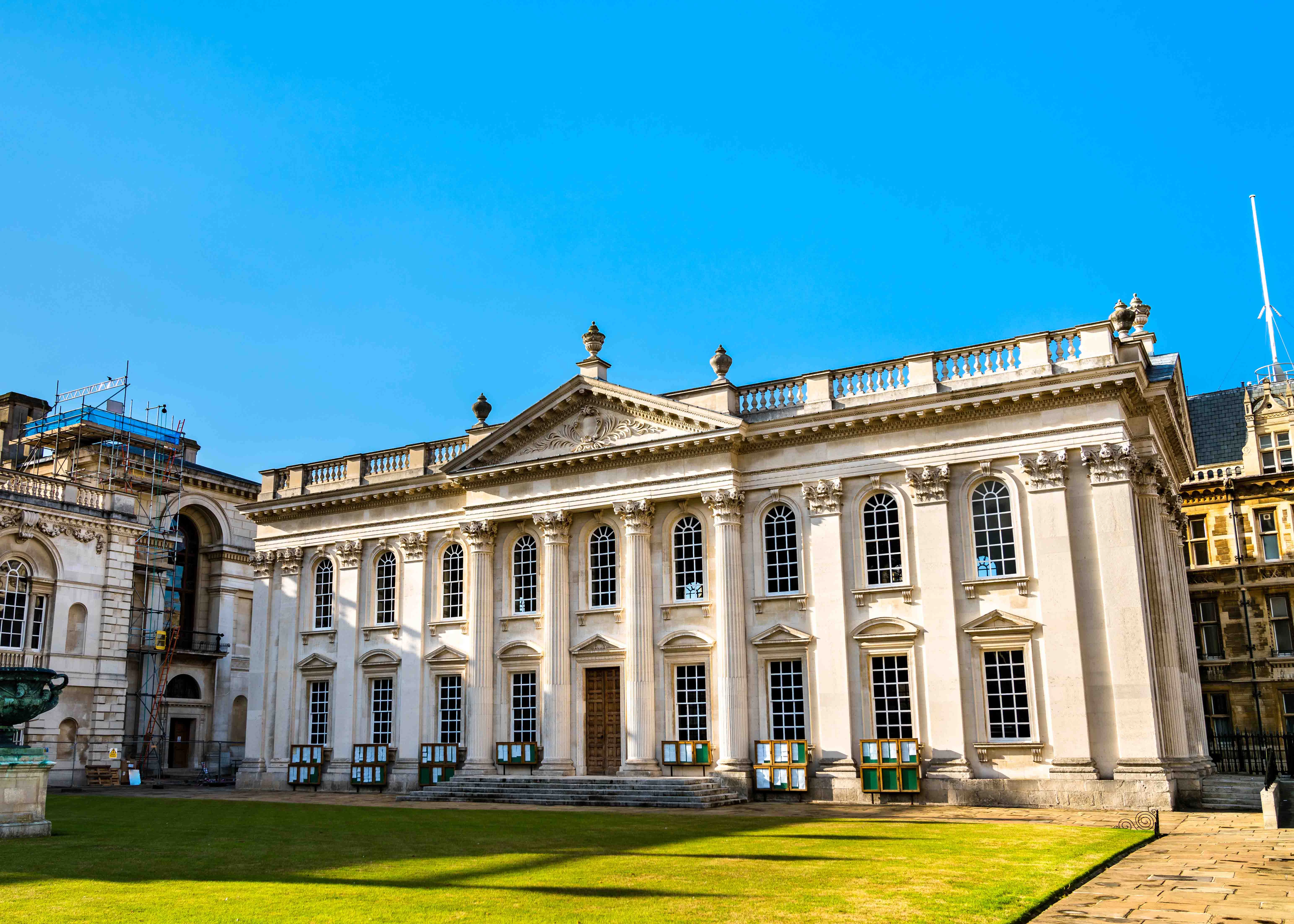 Senate House in Cambridge, England, with classical architecture and a clear blue sky.