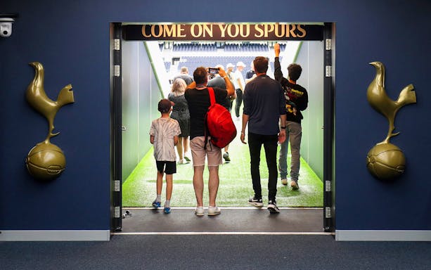 Tourists walking through the tunnel at Tottenham Hotspur Stadium.