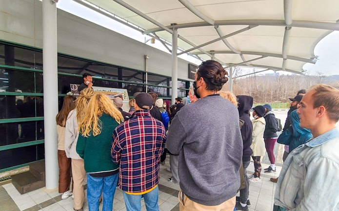 Tour group listening to a guide at DMZ Suspension Bridge, South Korea.