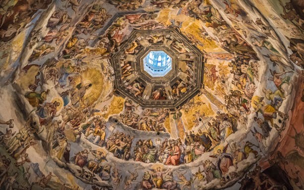 Frescoes inside the Cupola of Duomo of Florence depicting religious scenes.