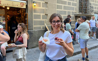 Tourist enjoying wine and local food on a Florence food tour.
