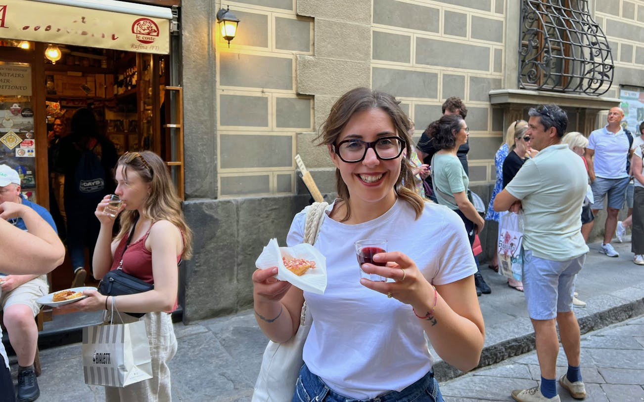 Tourist enjoying wine and local food on a Florence food tour.