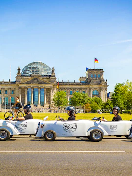 Hot rod cars in front of the Reichstag building, Berlin, during a city tour.