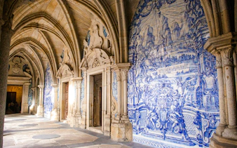 Interior of Igreja do Carmo in Portugal with blue tile murals and arched ceilings.