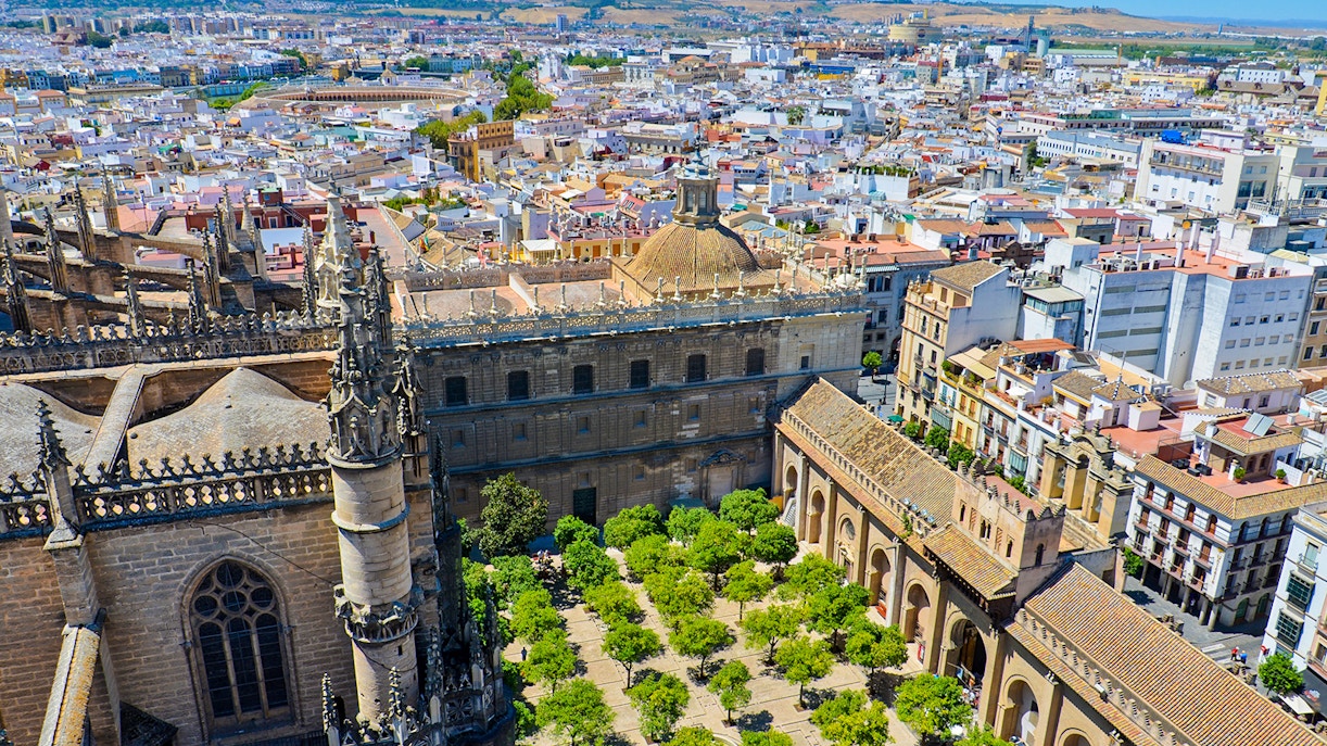 View from La Giralda tower overlooking Seville's historic architecture and cityscape.