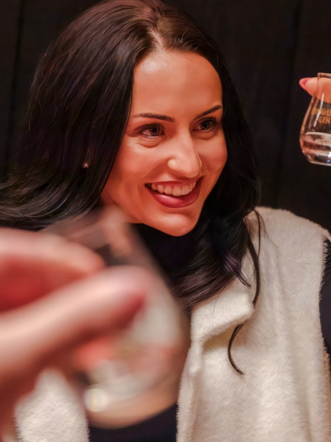 Woman enjoying a gin tasting experience in London.