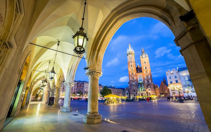 Krakow's Rynek Underground Museum entrance with St. Mary's Basilica in the background.