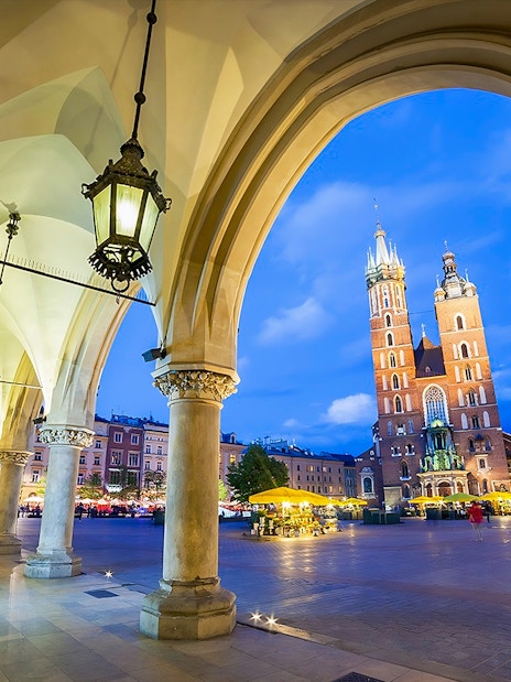 Krakow's Rynek Underground Museum entrance with St. Mary's Basilica in the background.