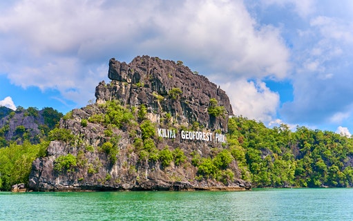 Kilim Geoforest Park sign on rocky hill, Langkawi, Malaysia.