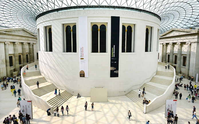 Tour group exploring the Great Court of the British Museum, London.
