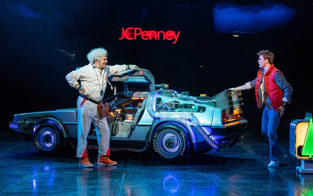 Two characters with a DeLorean time machine on stage, "Back to the Future" theme.