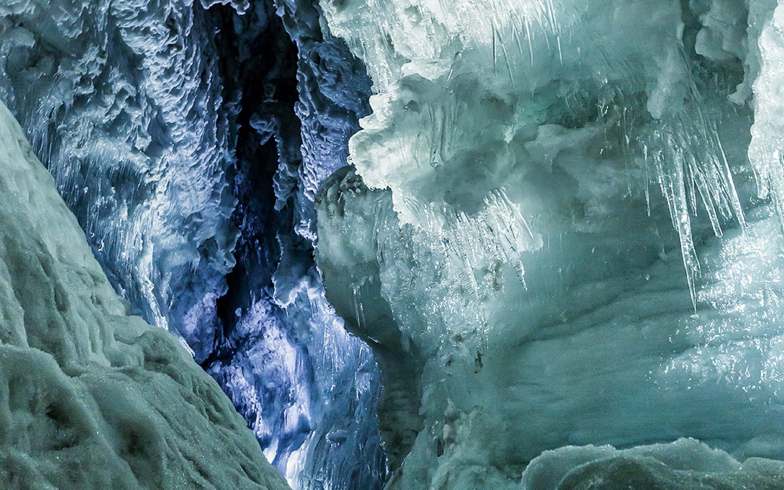 Ice tunnels inside Langjökull Glacier with intricate ice formations.