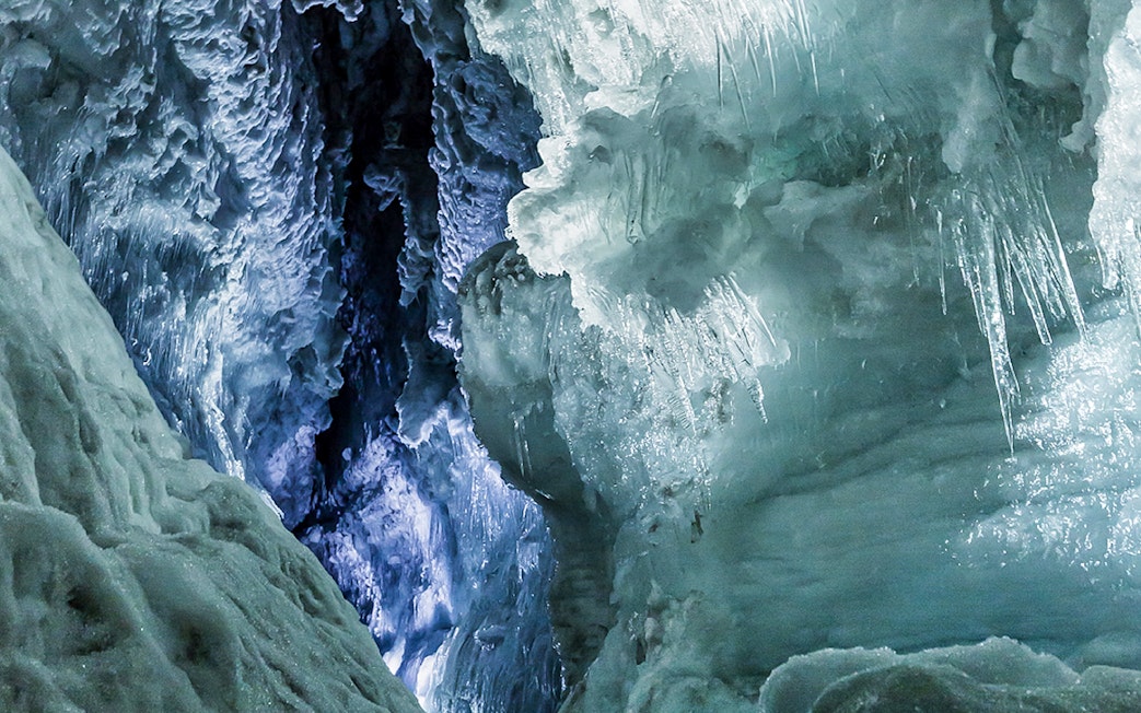 Ice tunnels inside Langjökull Glacier with intricate ice formations.
