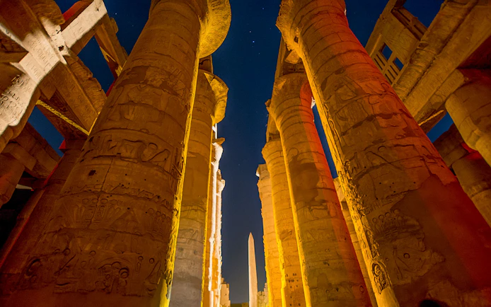 Karnak Temple columns illuminated during Sound and Light show, Luxor, Egypt.