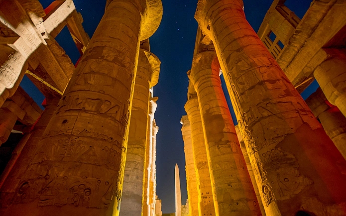 Karnak Temple columns illuminated during Sound and Light show, Luxor, Egypt.