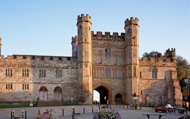 Battle Abbey gatehouse in East Sussex, England, with historic stone architecture.