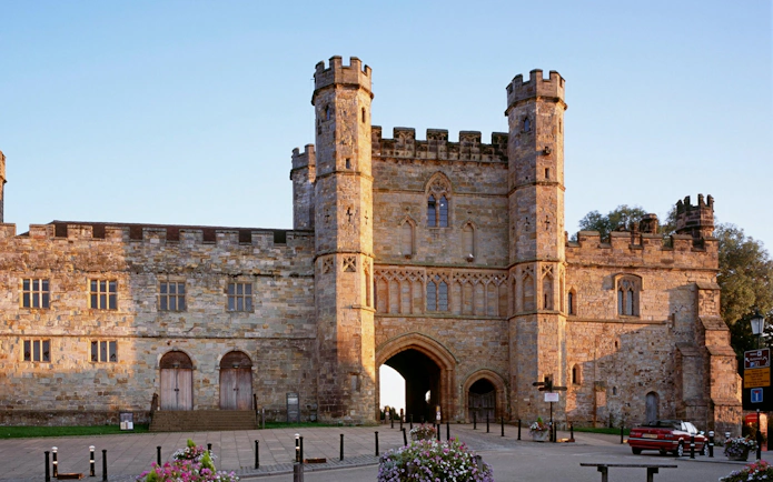 Battle Abbey gatehouse in East Sussex, England, with historic stone architecture.