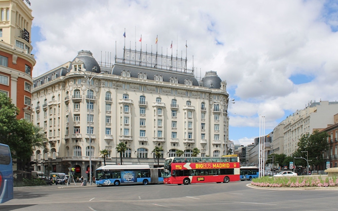 Big Bus Madrid tour passing by the historic Palace Hotel in Madrid.
