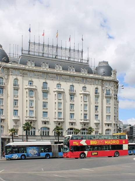 Big Bus Madrid tour passing by the historic Palace Hotel in Madrid.