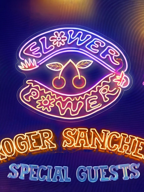 Neon sign for Flower Power event at Pacha Ibiza with peace symbol and music notes.