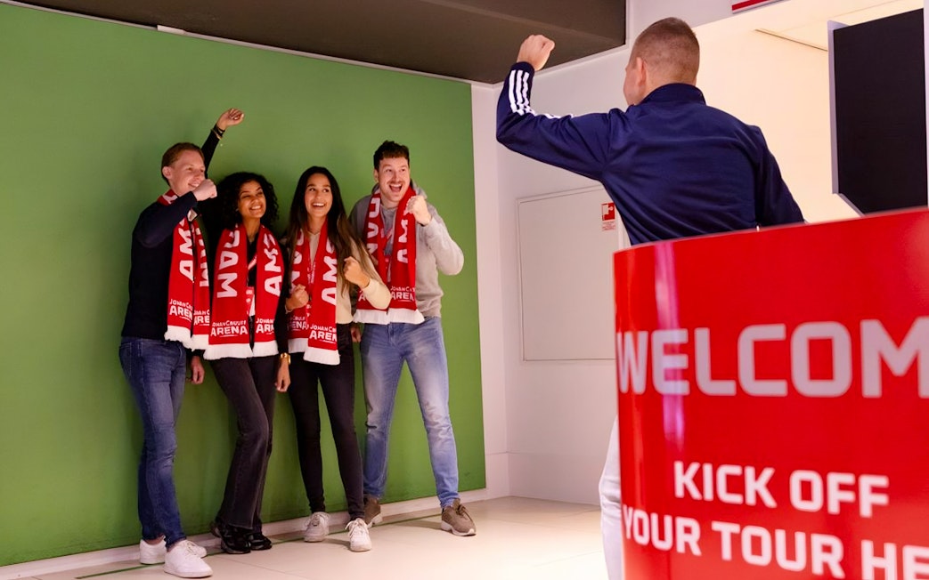 Visitors posing with scarves during Johan Cruijff ArenA VIP Tour.