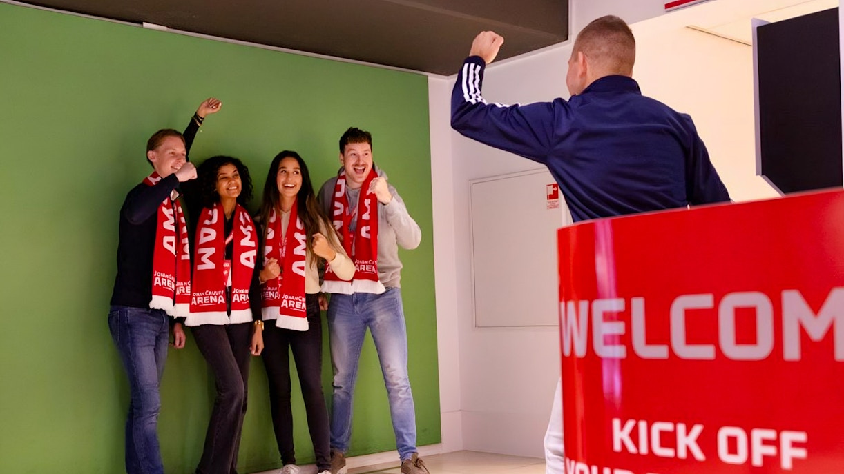 Visitors posing with scarves during Johan Cruijff ArenA VIP Tour.