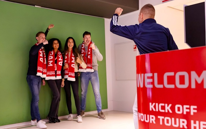 Visitors posing with scarves during Johan Cruijff ArenA VIP Tour.